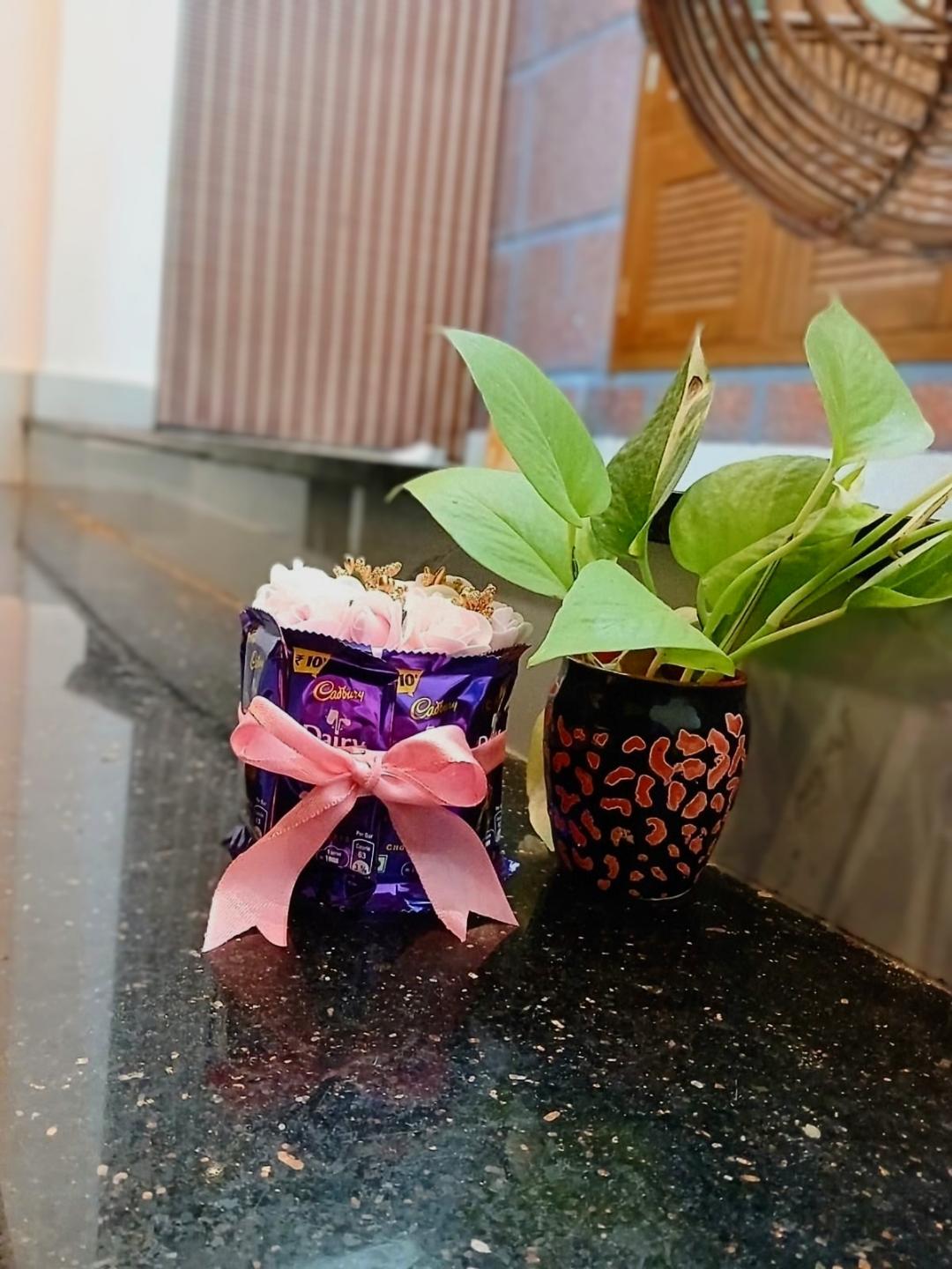 Mini Chocolate Tower with Dairy Milk chocolates, pink floral accents, and a pink bow
